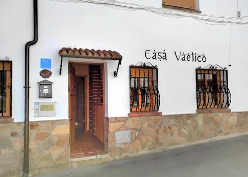 a white building with a door and windows at Casa Vaélico in Arenas de San Pedro