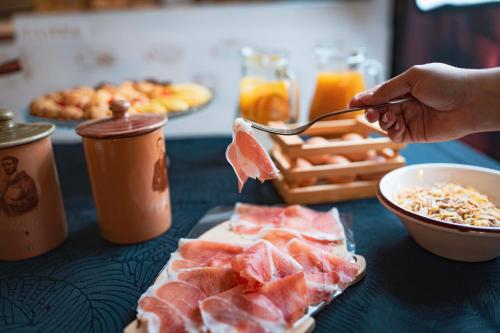 a person eating a piece of fruit with a spoon at B&B Casa Madeo in San Demetrio Corone