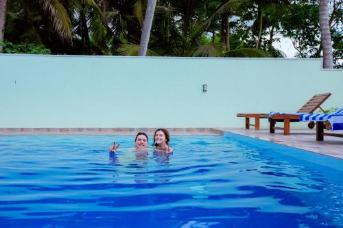 two women swimming in a swimming pool at My Resort Yala in Tissamaharama