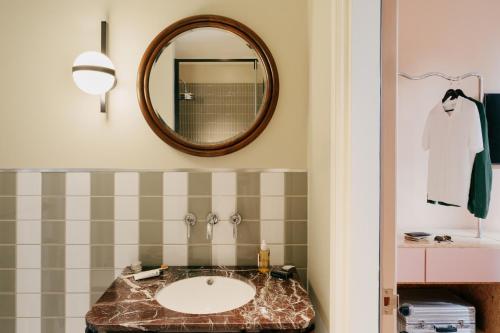 a bathroom with a sink and a mirror at The Hoxton, Florence in Florence