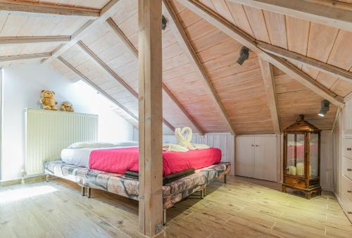 a bedroom with a large bed in a attic at AGALI HOUSE in Limenaria