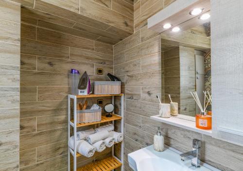 a bathroom with a sink and a mirror at AGALI HOUSE in Limenaria