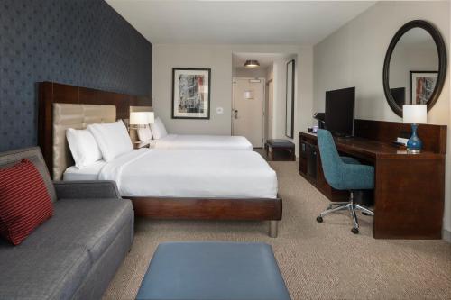 a hotel room with a bed and a desk and a computer at Hilton Garden Inn Washington DC/Georgetown Area in Washington