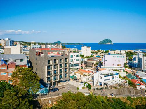 an aerial view of a city with the ocean at Hotel Yeon in Seogwipo