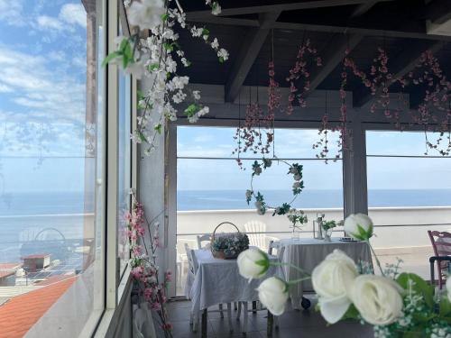a table in a room with a view of the ocean at Palese Profumo di Mare in Santo Spirito
