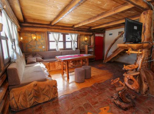 a living room with a couch and a table at Ethno Village Dolina Mira in Pale