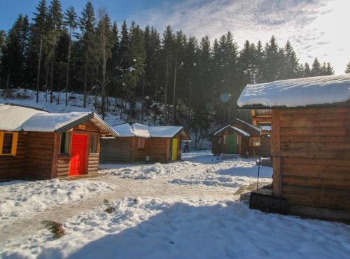 a group of wooden cabins in the snow at Ethno Village Dolina Mira in Pale