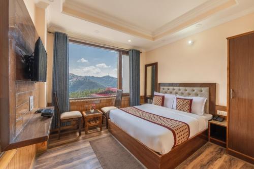 a hotel room with a bed and a large window at Hotel Charming Hills By Him Haults Hospitality in Shimla