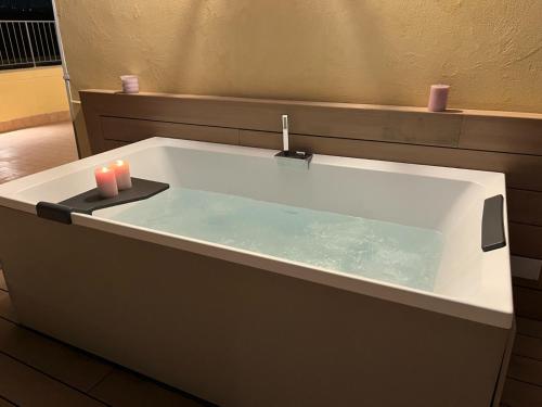 a bath tub with two candles sitting in it at Daca luxury rooms in Naples