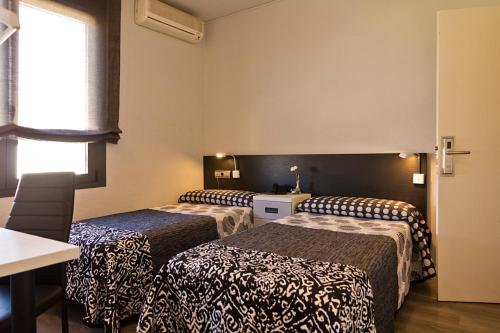 Ένα ή περισσότερα κρεβάτια σε δωμάτιο στο Hostal Plaza