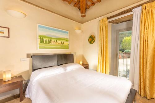 a bedroom with a white bed and a window at Locanda del Vino Nobile, Montepulciano Rooms AC, WI-FI in Sant'Albino
