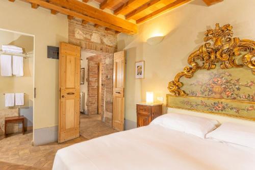 a bedroom with a white bed and a large mirror at Locanda del Vino Nobile, Montepulciano Rooms AC, WI-FI in Sant'Albino