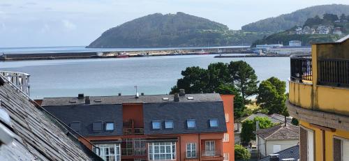 a view of a river with buildings and a train at Las Gaviotas in Viveiro