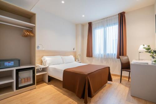 Postel nebo postele na pokoji v ubytování Hotel Glòries