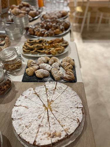 a table with many different types of food on it at Americana Beach House in Rimini