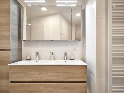a bathroom with a sink and a mirror at The Mountain Suite Top 11 - Tauplitz Residences by AA Holiday Homes in Tauplitz