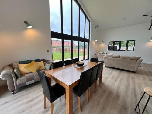 a living room with a table and a couch at Stylish & Spacious Getaway in Norwich