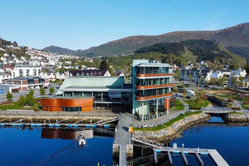 a large building next to a body of water at Quality Hotel Ulstein in Ulsteinvik