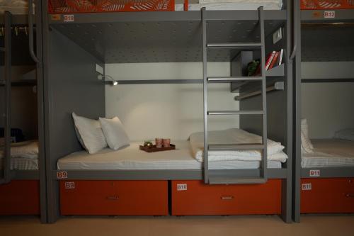 a bunk bed with two beds in a room at OSTELO Mumbai Airport Hostel in Mumbai