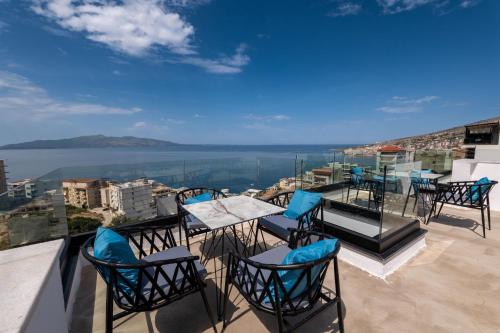 a group of chairs and tables on a balcony at Litan Hotel in Sarandë