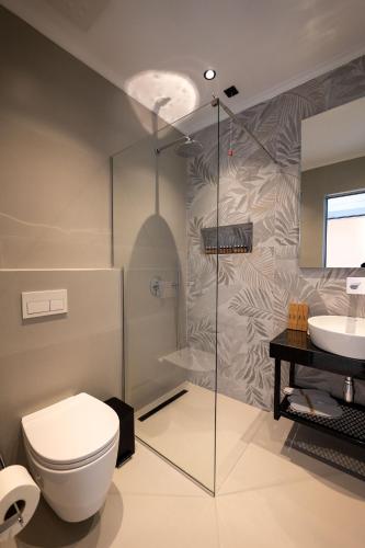 a bathroom with a toilet and a sink at Litan Hotel in Sarandë
