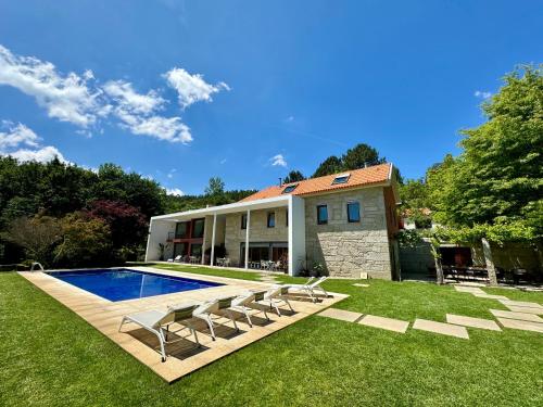 a house with a swimming pool in the yard at Quinta Trindade in Arouca