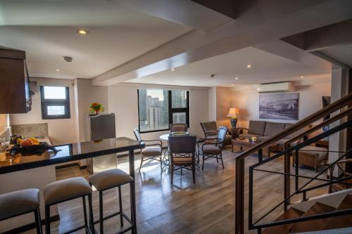 a living room with a table and chairs and a dining room at 1898 Hotel Colonia En Las Filipinas in Manila