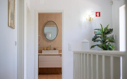a white bathroom with a sink and a mirror at Villa Ílios - Porto de Mós, Lagos in Lagos