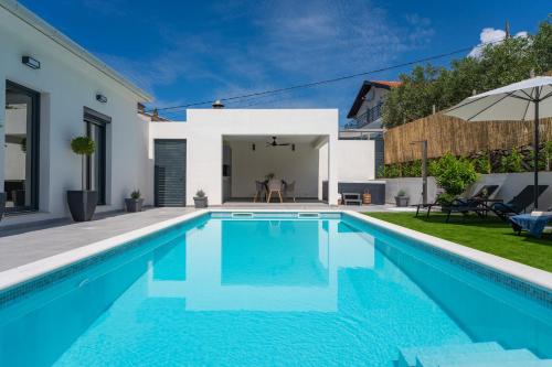 a swimming pool in the backyard of a house at NEW Apartment Gironi with Pool, Jacuzzi in Tugare