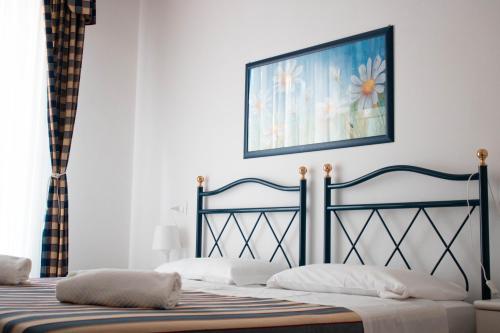 1 dormitorio con 2 camas y una foto en la pared en Hotel Riviera, en Lido di Jesolo
