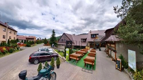 a car parked on a street next to a building at SOVA Hotel&Restaurant in Ždiar