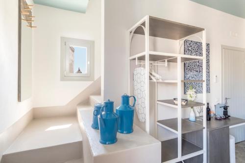 a room with blue vases sitting on a shelf at Fico! Apartments by MONHOLIDAY in Monopoli