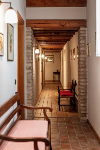 a hallway with chairs and a table in a building at Agriturismo Il Palazzone in Montegalda