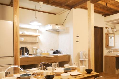 a kitchen with a table with dishes on it at 木庵 "Moku-an"Tiny house go to Kyoto Nara in 1 hour in Osaka