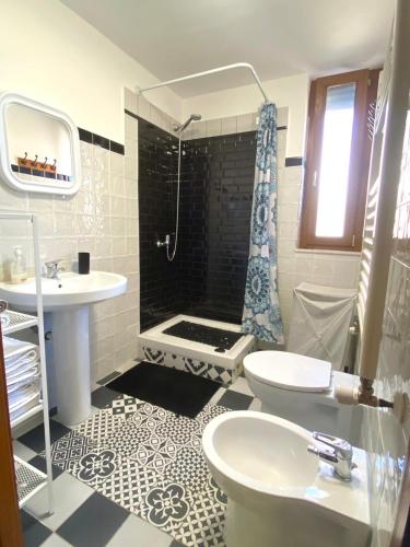 a bathroom with a shower and a toilet and a sink at MarePorto House in Fiumicino