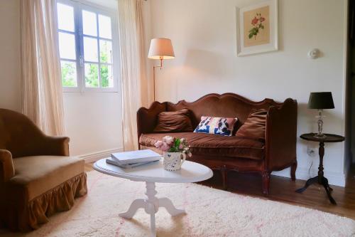 a living room with a couch and a table at La Grenouillère in Saint-Estèphe