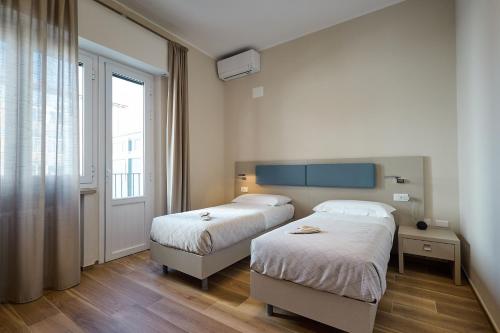 Postel nebo postele na pokoji v ubytování B&B aMare - Il Battito del Mare a due passi