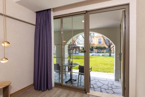a sliding glass door leading to a patio with a table at Ema Houses in Antalya