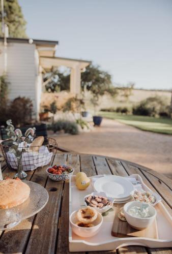 a table with plates and bowls of food on it at Ravenswood Farmhouse in Rylstone