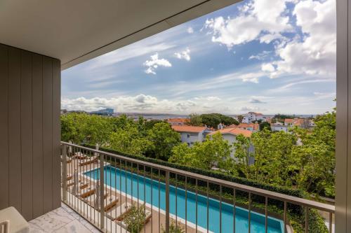 a balcony with a view of a swimming pool at Legacy Hotel Cascais, Curio Collection By Hilton in Cascais