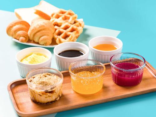 a tray of food with waffles and other condiments at Comfort Inn Naha Tomari Port in Naha
