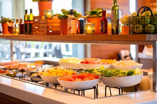 a buffet line with bowls of food on display at Quality Hotel Ulstein in Ulsteinvik