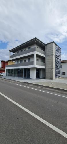 a large building on the side of a road at Dormi-RE Affittacamere in Reggio Emilia