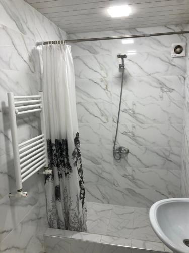 a bathroom with a shower curtain and a sink at Armen’s Apartment in Yerevan