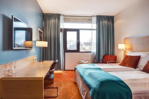 Pokój hotelowy z łóżkiem i biurkiem w obiekcie Quality Hotel Ulstein w mieście Ulsteinvik