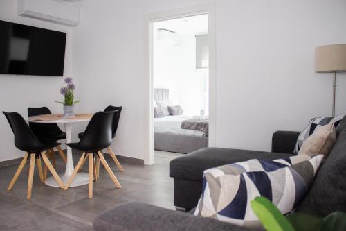a living room with a couch and a table and chairs at Gaviotas Beach Golf in Almerimar