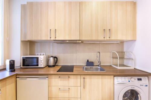 a kitchen with a sink and a microwave at RP4 RégiPosta Apartment in Budapest