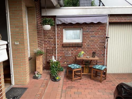 a small patio with a table and two chairs at Gästehaus Steffen in Upgant-Schott