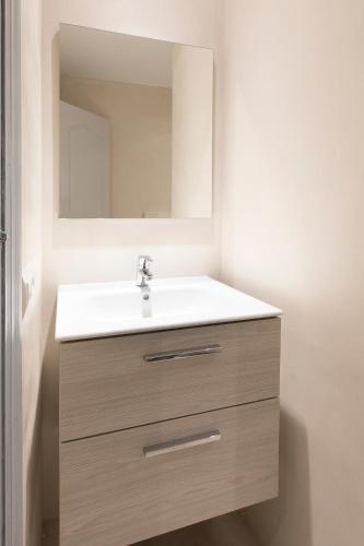 a bathroom with a sink and a mirror at Ca Sa Vilda in Es Pujols