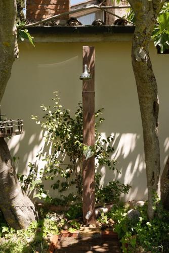 a bird feeder in front of a building with trees at La Vittoria 10 – La Soglia della Val d’Orcia in Chianciano Terme